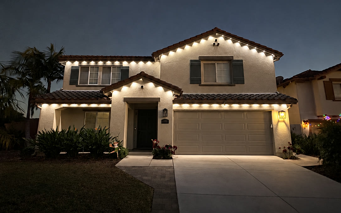 Warm-white roofline lighting on an ordinary evening