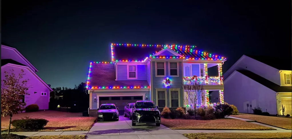 Permanent roofline lighting — warm white at dusk