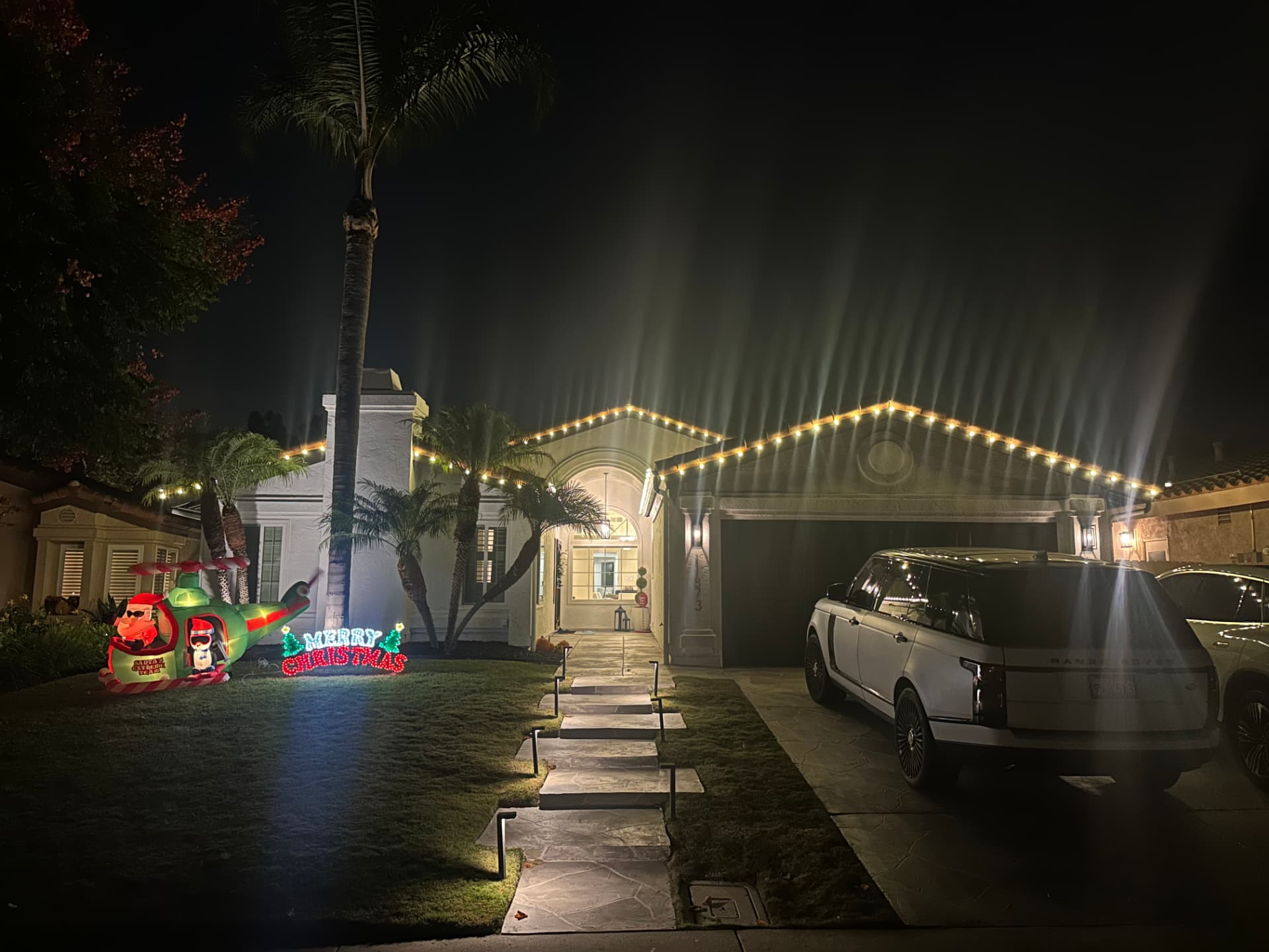 Residential property, roofline and landscape lighting at night